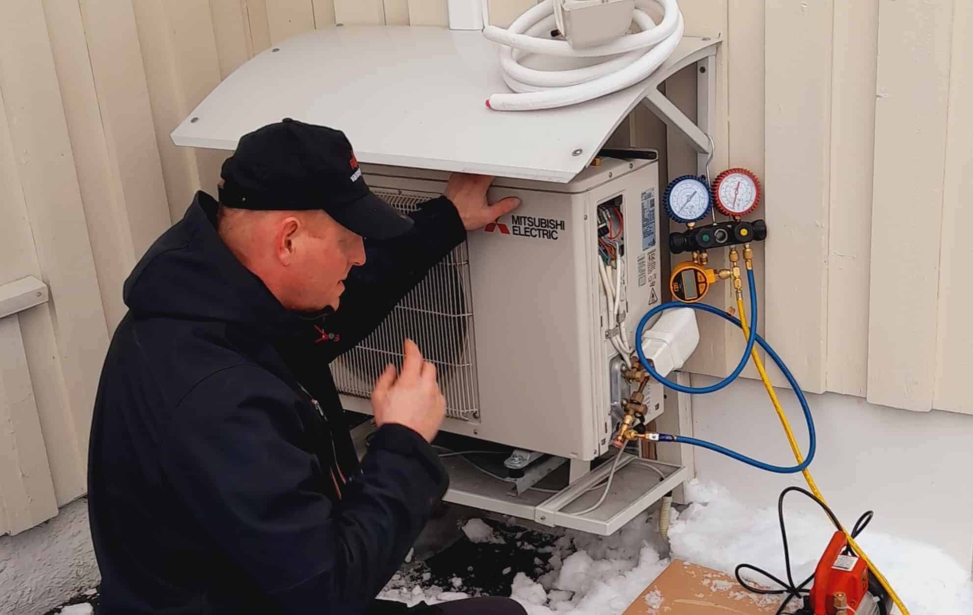 a man working on a air conditioner