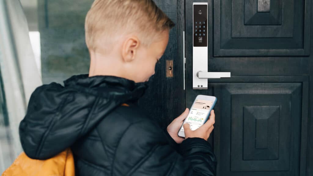 a boy using a phone to open a door