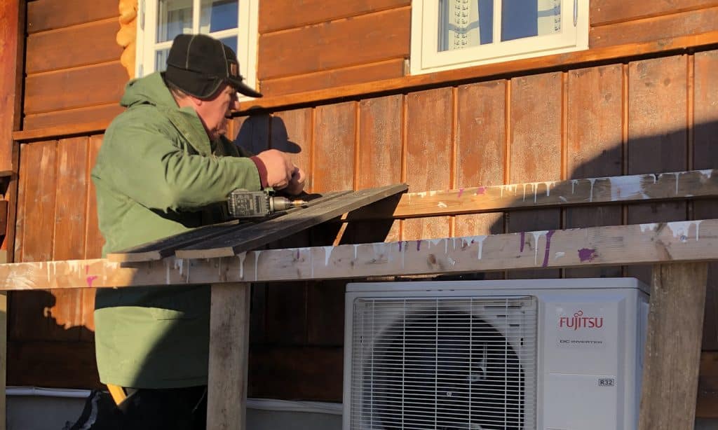 a man working on a wood plank