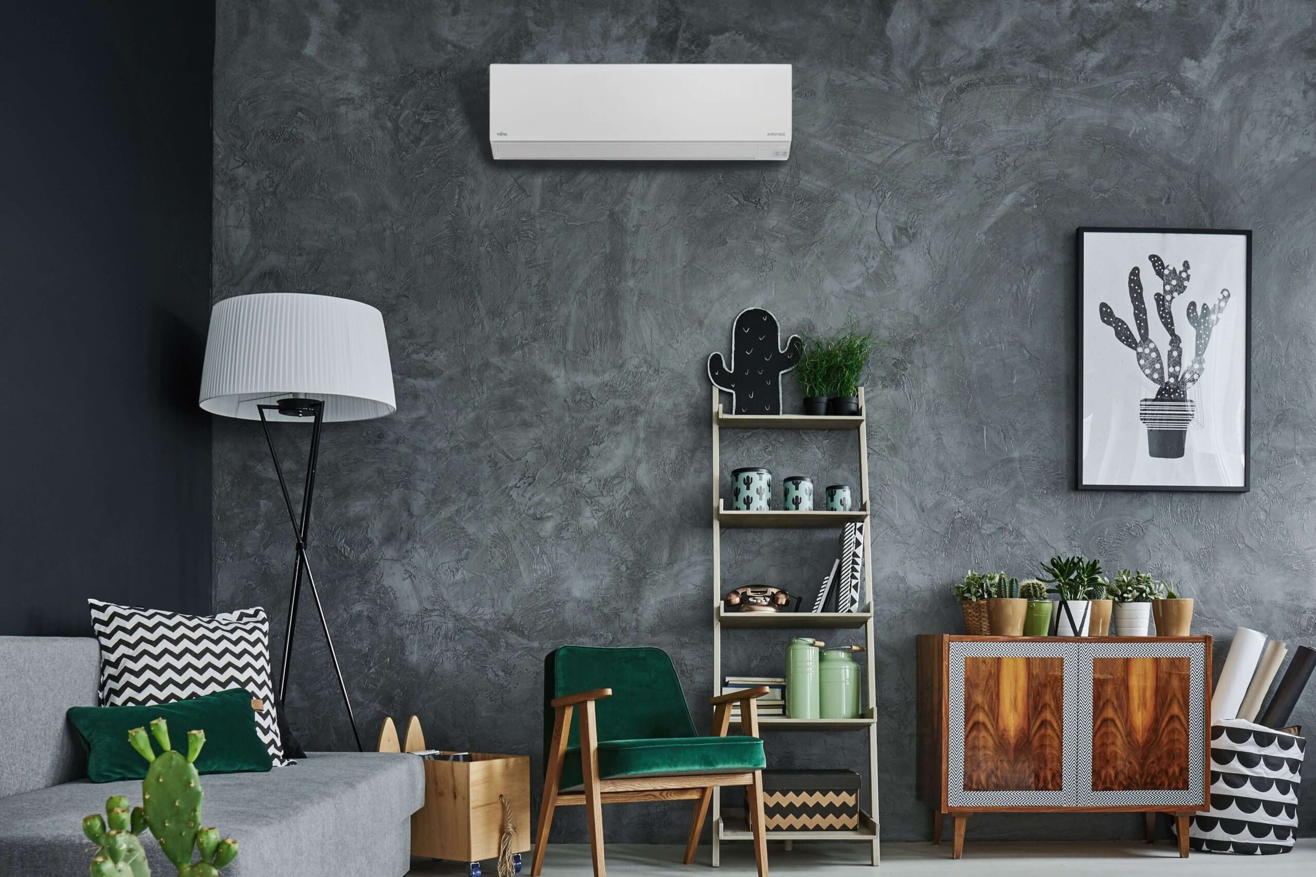 a room with a couch and a bookcase and a lamp